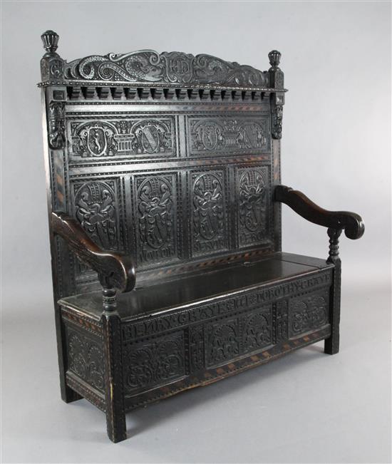 A 17th century style inlaid oak monks bench, W.4ft 4in. D.1ft 11in. H.5ft
